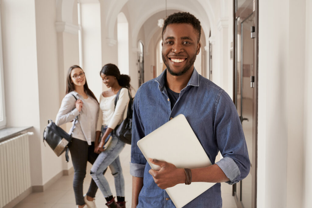positivity african student wearing shirt holding notes. positivity african student wearing shirt holding notes.
